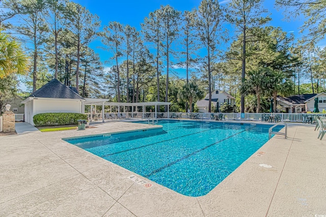 community pool featuring a patio, fence, and a pergola