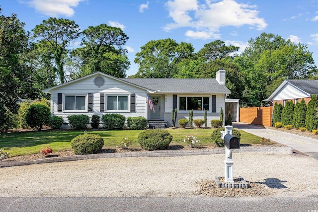 single story home featuring fence, a chimney, and a front yard