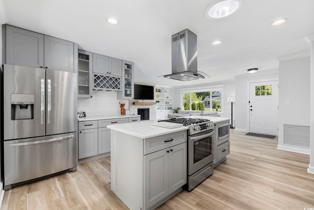 kitchen with appliances with stainless steel finishes, visible vents, light countertops, island exhaust hood, and gray cabinetry