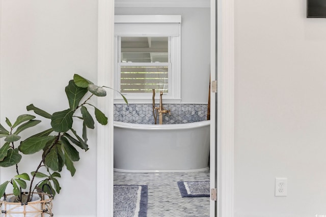 interior space featuring decorative backsplash and a soaking tub