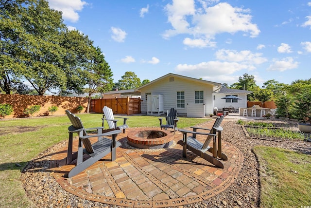 view of patio with fence and a fire pit
