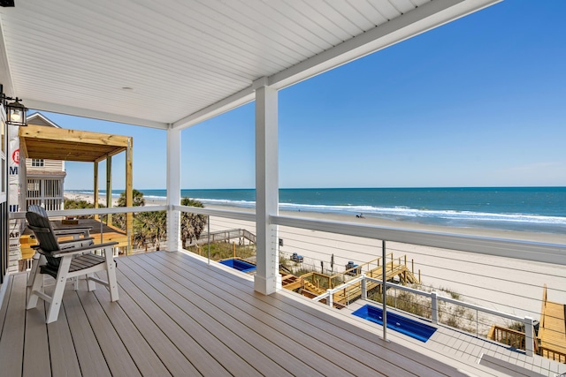 deck with a water view and a beach view