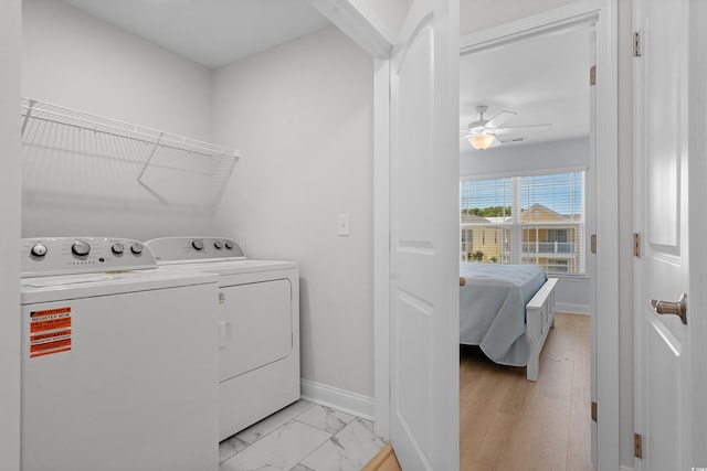 laundry room featuring independent washer and dryer, ceiling fan, laundry area, marble finish floor, and baseboards