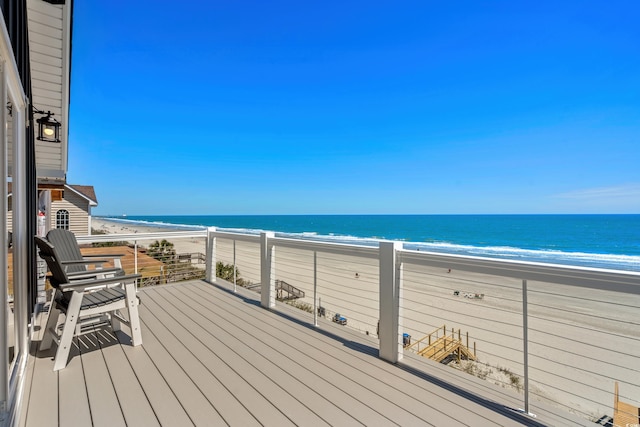 deck featuring a view of the beach and a water view