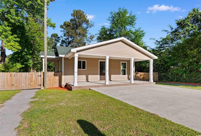 bungalow-style home featuring covered porch, a gate, fence, a front lawn, and driveway