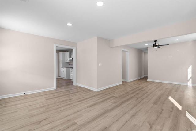 unfurnished living room with light wood-style floors, ceiling fan, baseboards, and recessed lighting