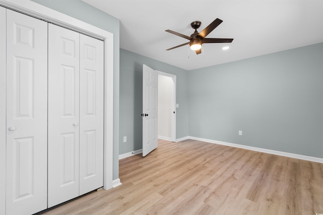 unfurnished bedroom featuring a closet, recessed lighting, baseboards, ceiling fan, and light wood-type flooring