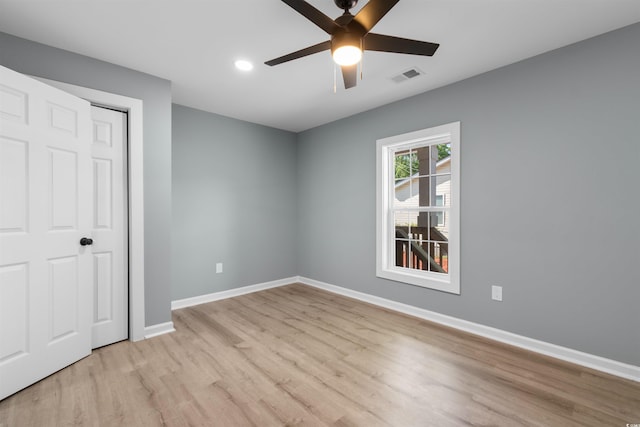 unfurnished bedroom featuring a closet, visible vents, baseboards, light wood-style floors, and recessed lighting