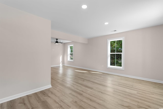 unfurnished room featuring a ceiling fan, visible vents, baseboards, light wood-style floors, and recessed lighting