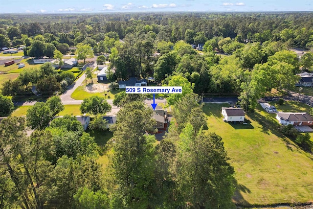 drone / aerial view with a forest view and a residential view
