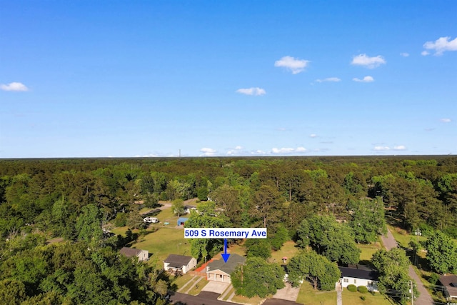 birds eye view of property featuring a forest view
