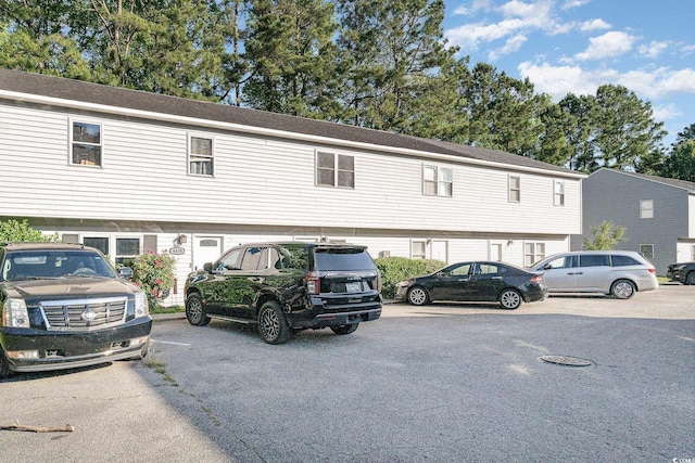 view of building exterior with uncovered parking