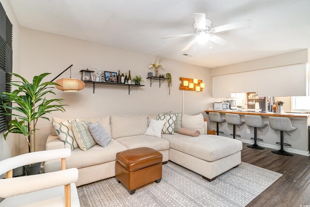 living area featuring ceiling fan and wood finished floors