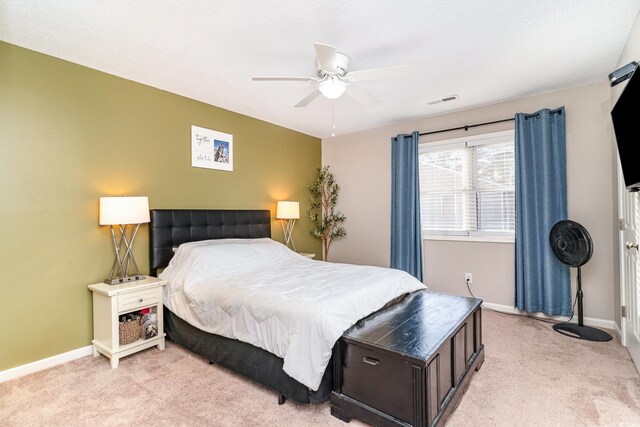 bedroom with baseboards, a ceiling fan, light colored carpet, and visible vents