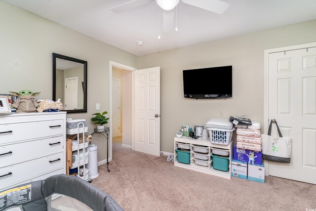 interior space featuring baseboards, ceiling fan, and carpet flooring