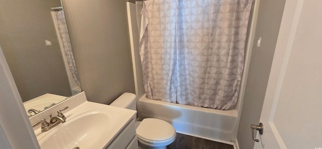 full bathroom with toilet, shower / tub combo, wood finished floors, and vanity