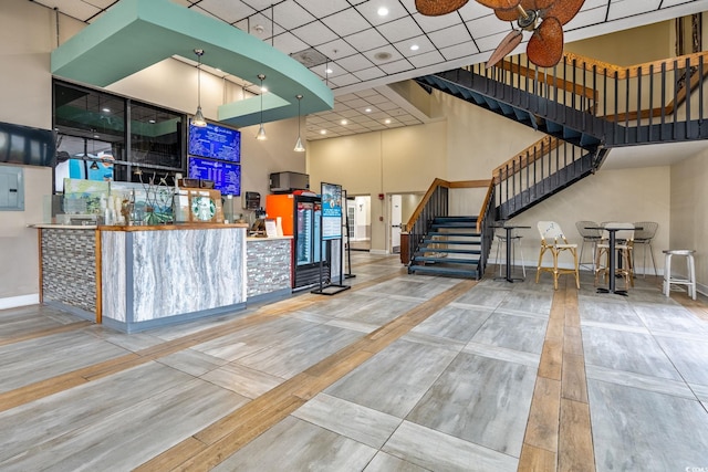 reception area featuring a ceiling fan and stairs
