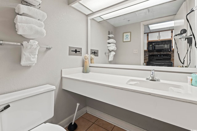 bathroom with tile patterned floors, vanity, and toilet