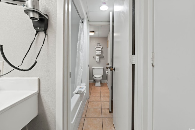 bathroom with tile patterned flooring and toilet