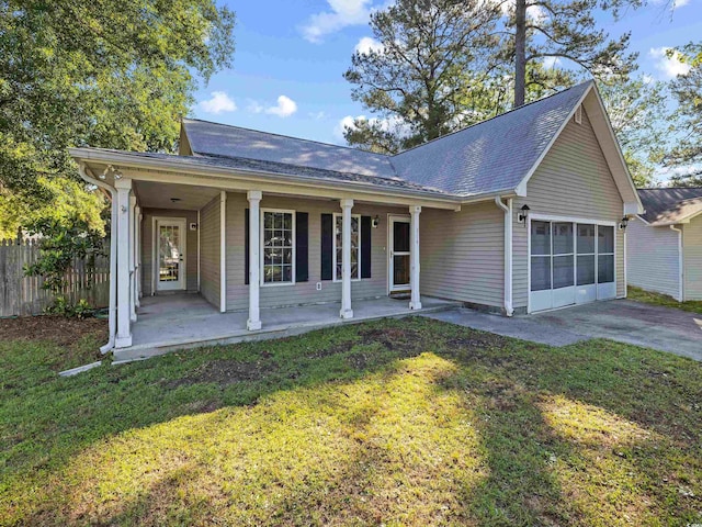 single story home with a front lawn, fence, covered porch, concrete driveway, and an attached garage