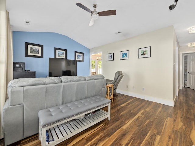 living area featuring a ceiling fan, visible vents, vaulted ceiling, wood finished floors, and baseboards