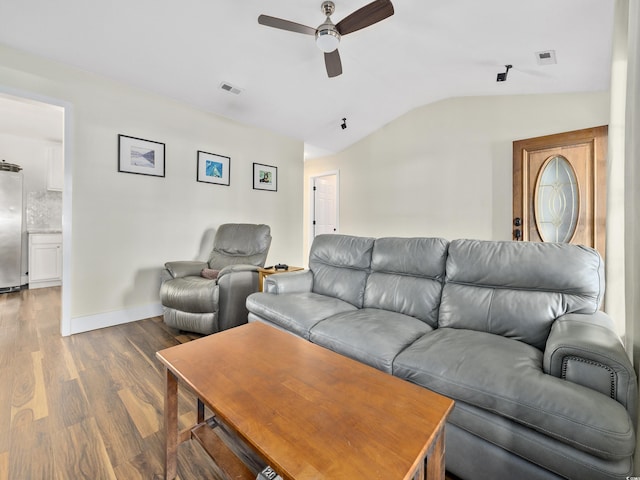 living area with visible vents, ceiling fan, lofted ceiling, and wood finished floors