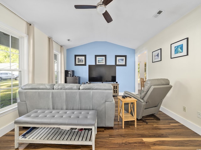 living area with ceiling fan, vaulted ceiling, plenty of natural light, and dark wood finished floors