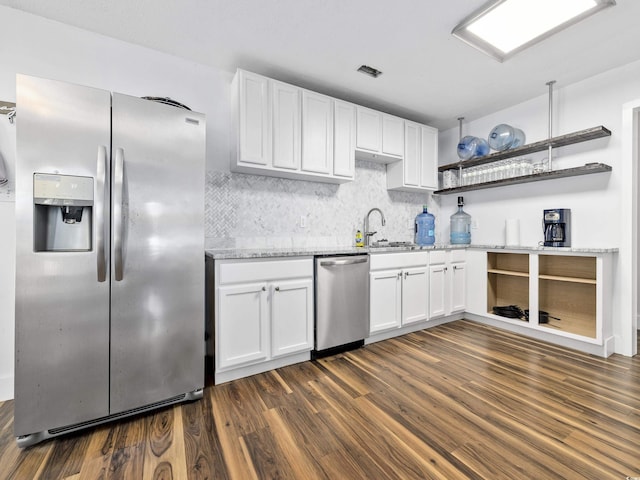 kitchen with appliances with stainless steel finishes, tasteful backsplash, open shelves, dark wood-style floors, and white cabinetry