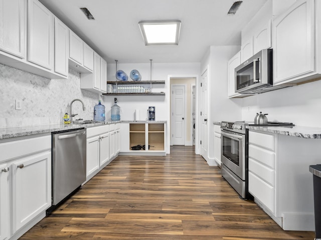 kitchen featuring dark wood-style flooring, open shelves, a sink, white cabinets, and stainless steel appliances
