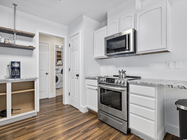 kitchen featuring washer / clothes dryer, light stone counters, stainless steel appliances, white cabinetry, and dark wood-type flooring