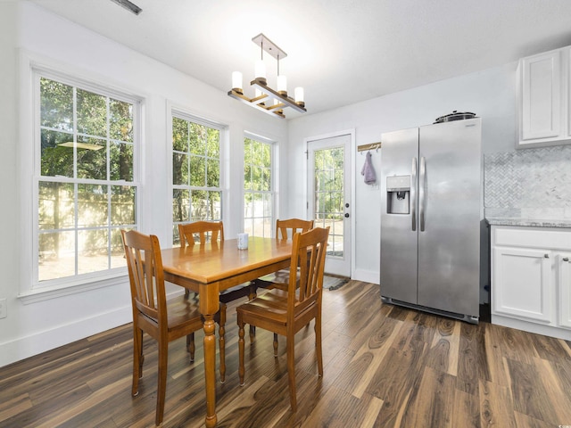 dining space with baseboards, dark wood-style flooring, and a notable chandelier