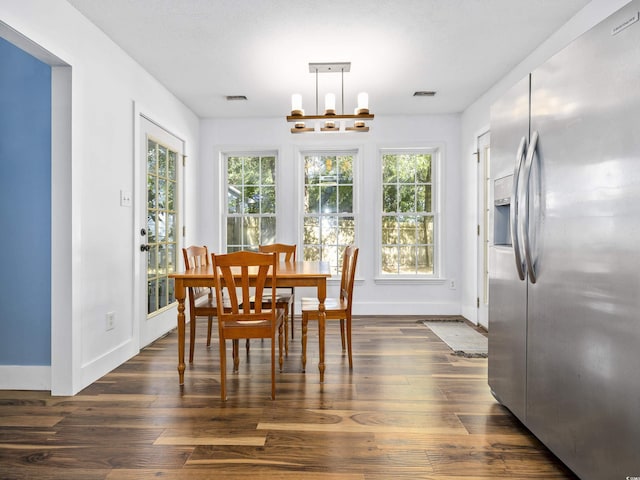 dining room featuring baseboards, visible vents, a wealth of natural light, and dark wood-type flooring