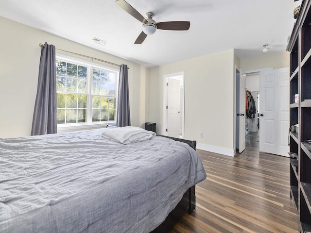 bedroom with a ceiling fan, baseboards, visible vents, and dark wood-style floors