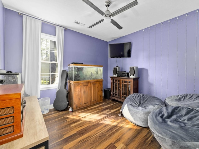 bedroom featuring a ceiling fan, vaulted ceiling, wood finished floors, and visible vents