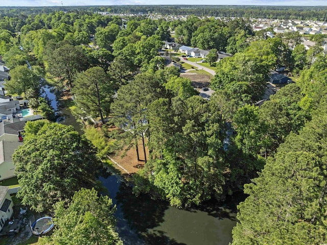 aerial view featuring a residential view, a water view, and a forest view