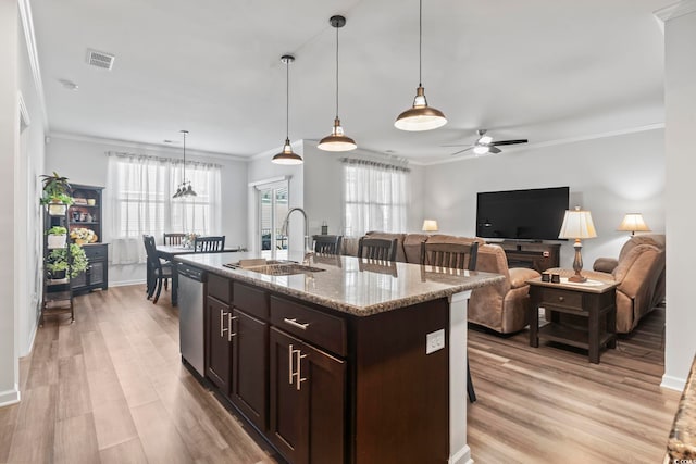 kitchen featuring visible vents, a ceiling fan, ornamental molding, dark brown cabinetry, and a sink
