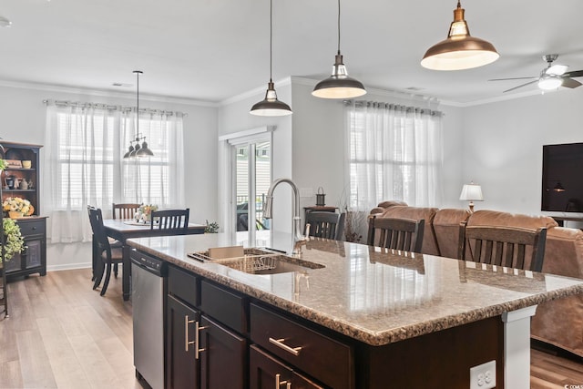 kitchen featuring a ceiling fan, light wood-style floors, open floor plan, a sink, and dishwasher