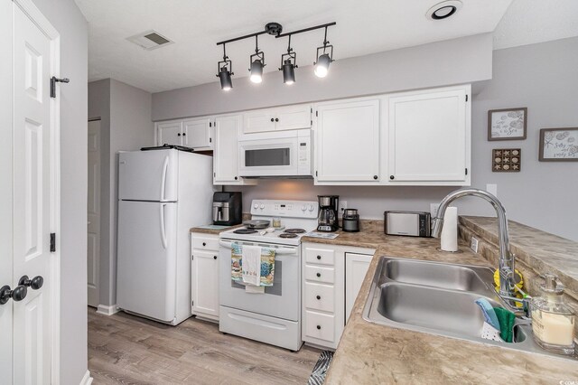 673 Tupelo Ln Unit G, Longs, SC 29568 - kitchen featuring white appliances, a sink, light wood-style floors, and light countertops