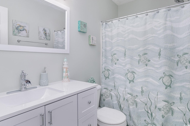 full bath featuring vanity and toilet