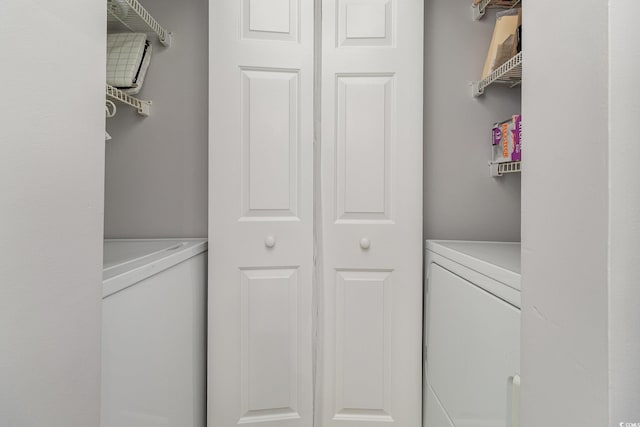 washroom with washing machine and clothes dryer and laundry area