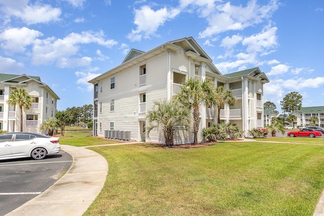 673 Tupelo Ln Unit G, Longs, SC 29568 - view of property exterior with a lawn, uncovered parking, and cooling unit
