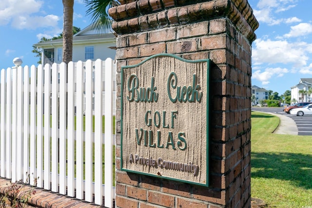 community / neighborhood sign with fence