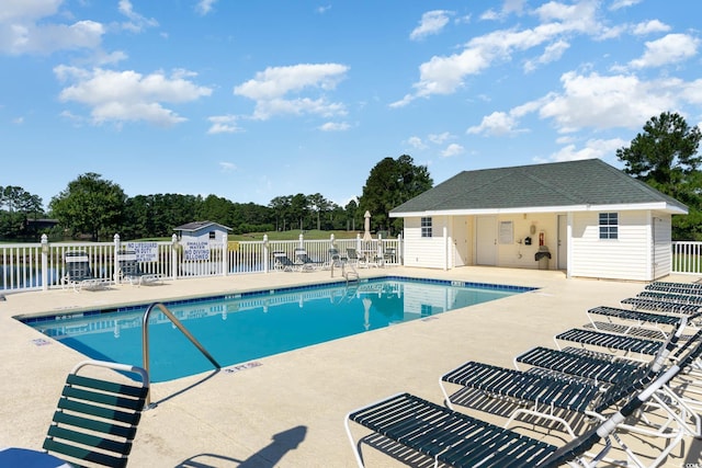 community pool featuring a patio and fence