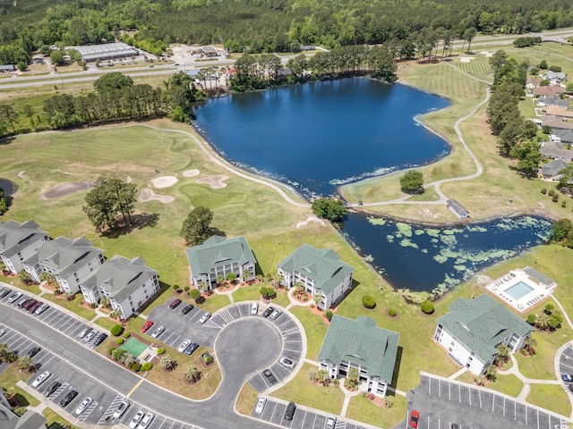 drone / aerial view with a water view, view of golf course, and a residential view