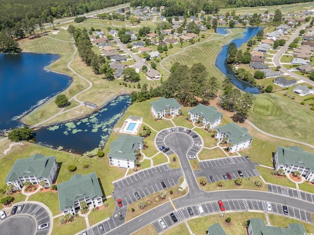 birds eye view of property with a residential view, view of golf course, and a water view