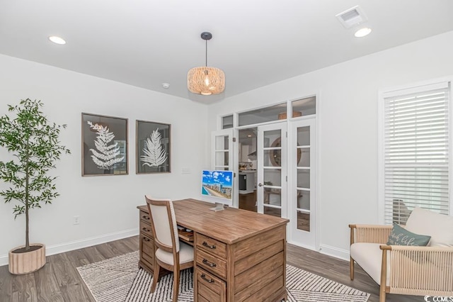 home office with baseboards, visible vents, french doors, and dark wood-type flooring