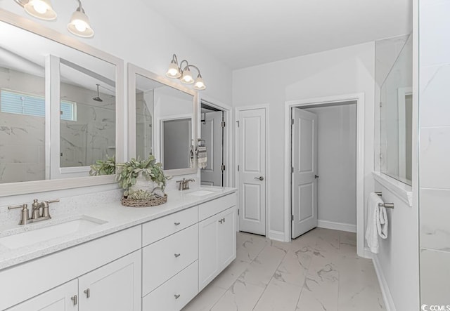full bathroom with double vanity, a marble finish shower, a sink, and marble finish floor
