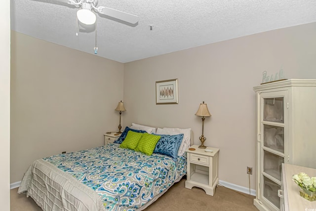 1100 Possum Trot Rd Unit H136, North Myrtle Beach, SC 29582 - carpeted bedroom featuring a textured ceiling and ceiling fan