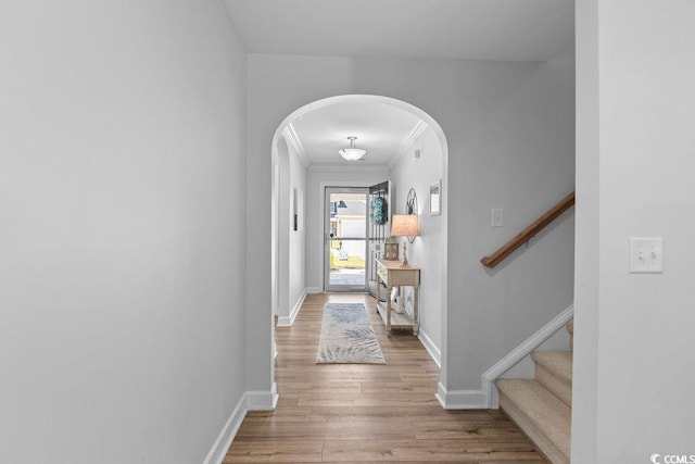 680 Twinflower St, Little River, SC 29566 - hallway with crown molding, arched walkways, baseboards, and wood finished floors