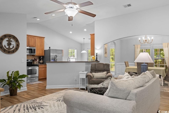 680 Twinflower St, Little River, SC 29566 - living area featuring light wood-style floors, visible vents, ceiling fan with notable chandelier, and arched walkways